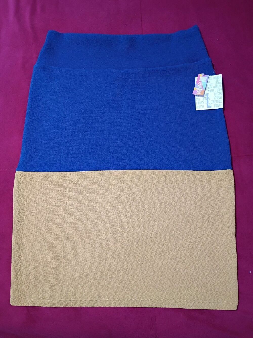 This LuLaRoe Cassie pencil skirt features a blue and tan colorblock design with